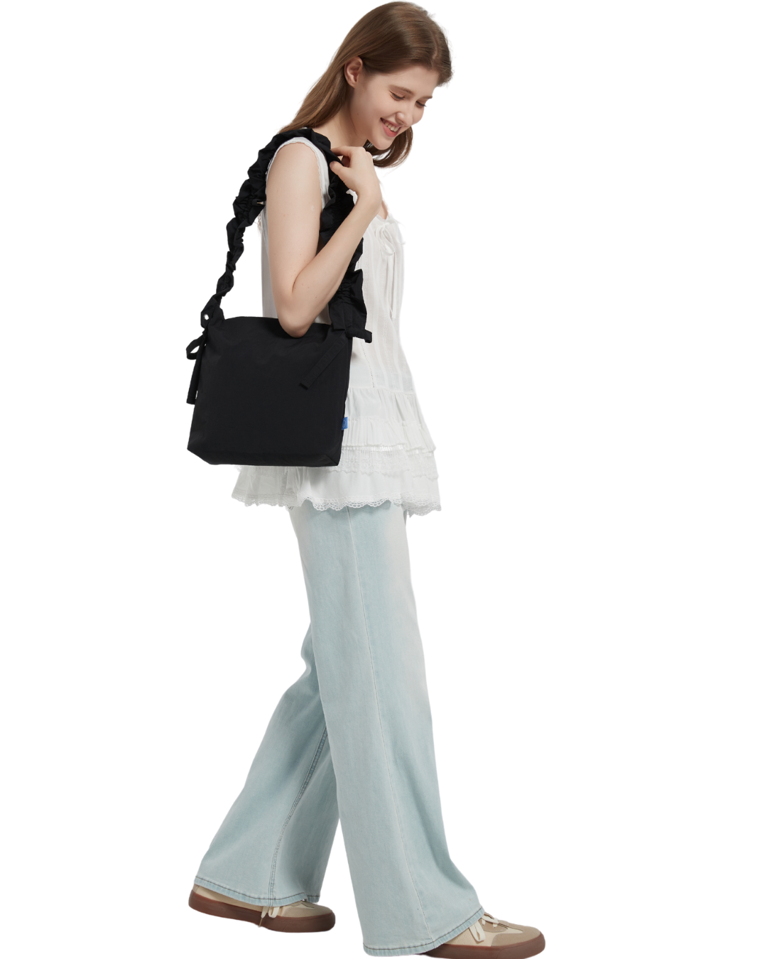 the petal bag in black shoulder carried by a model