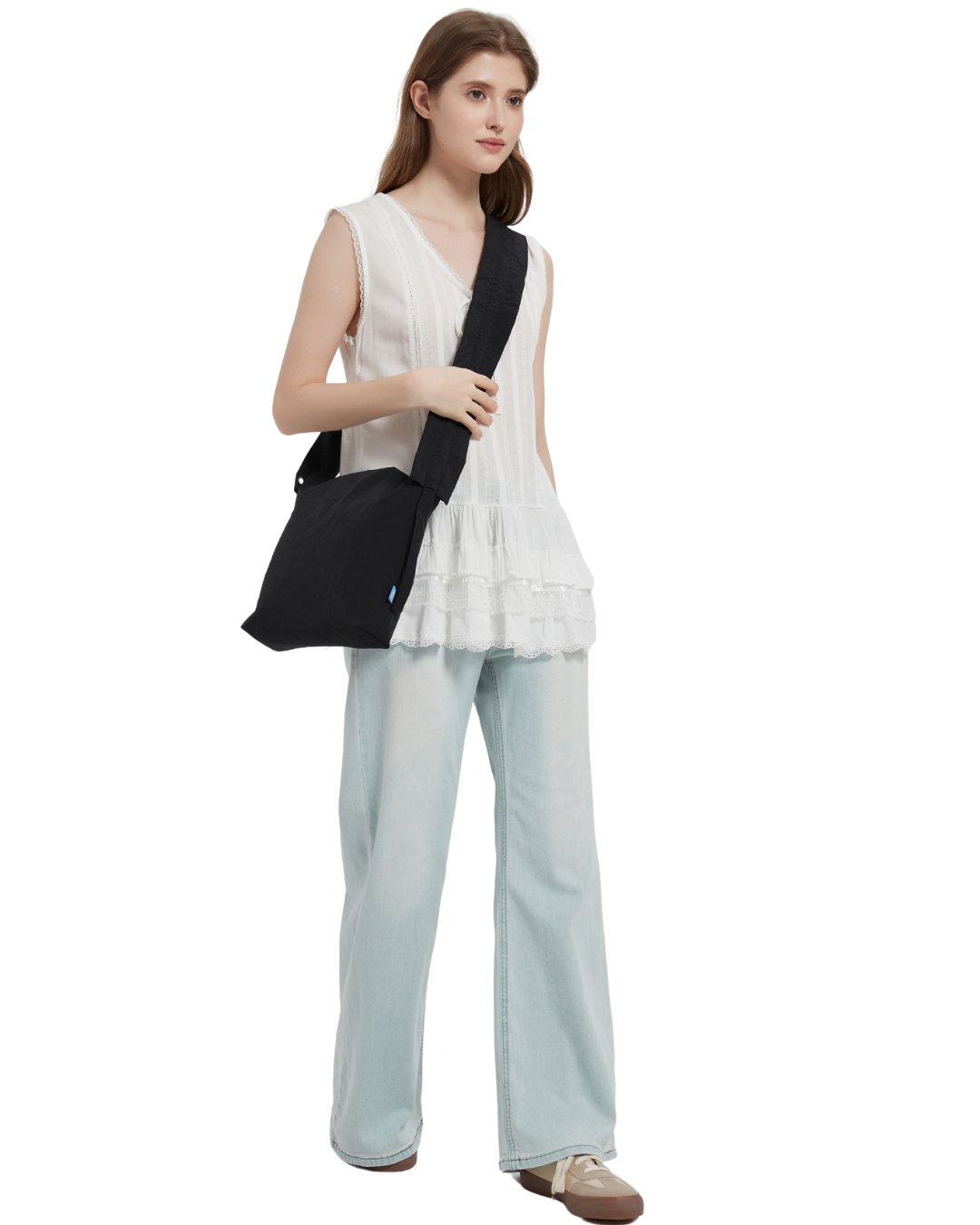 the petal bag in black sling carried by a model