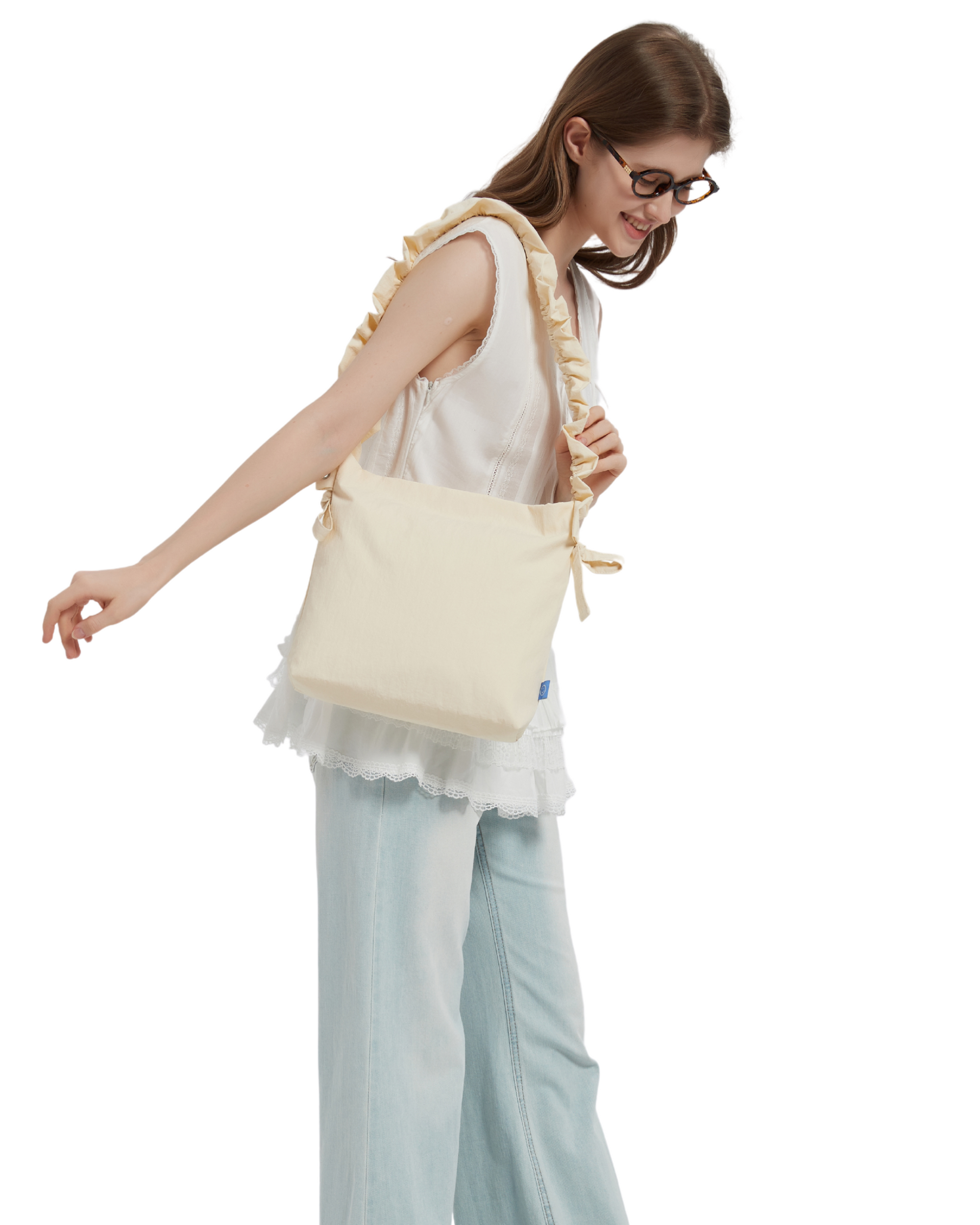 cream strap bag shoulder carried on a female model