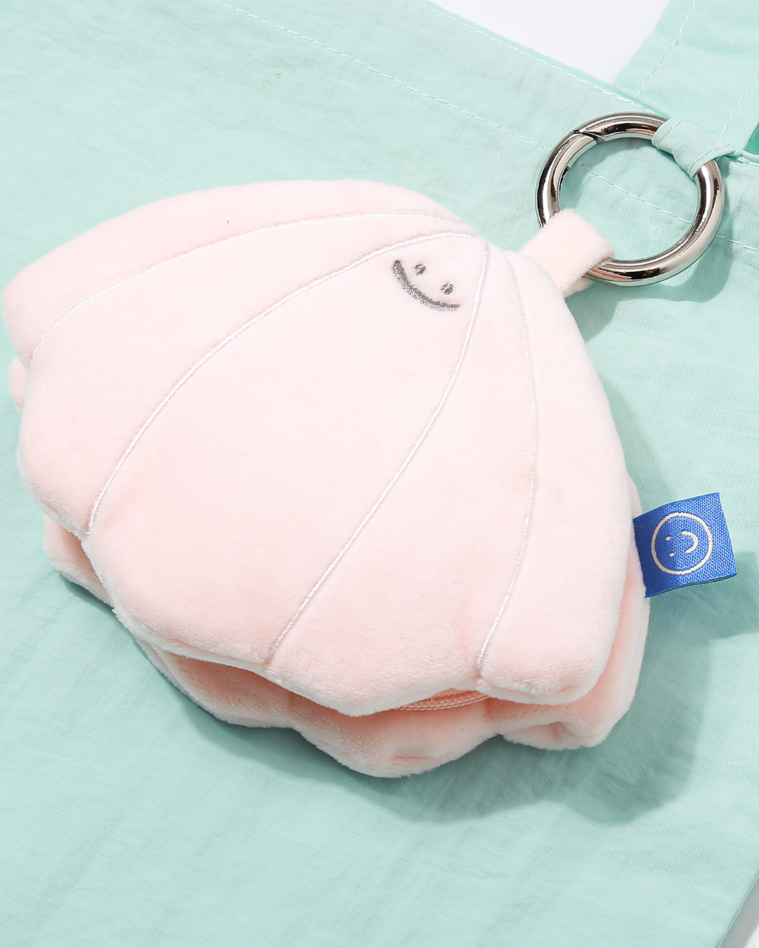 close up look on the embroidery details on the seashell plushie