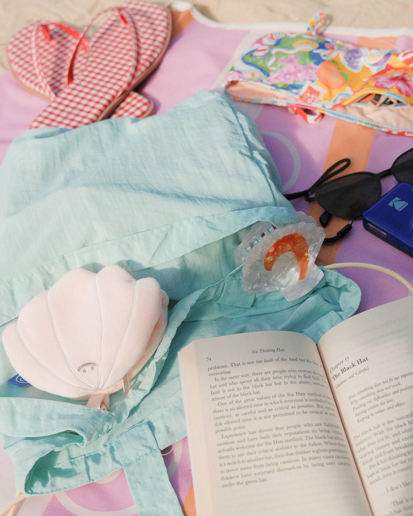 seashell plushie on a busy picnic mat