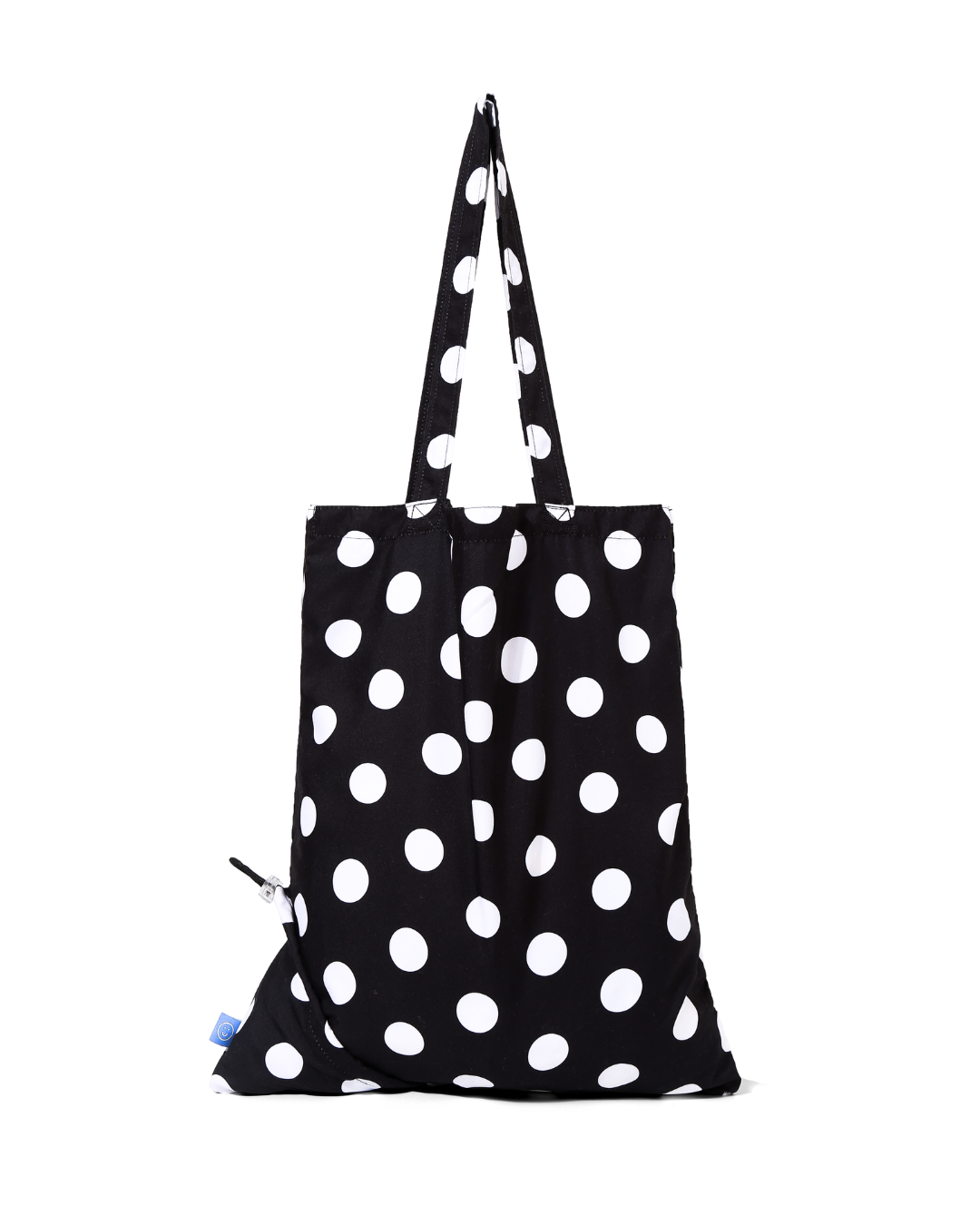 Black tote bag with white polka dots on a white background