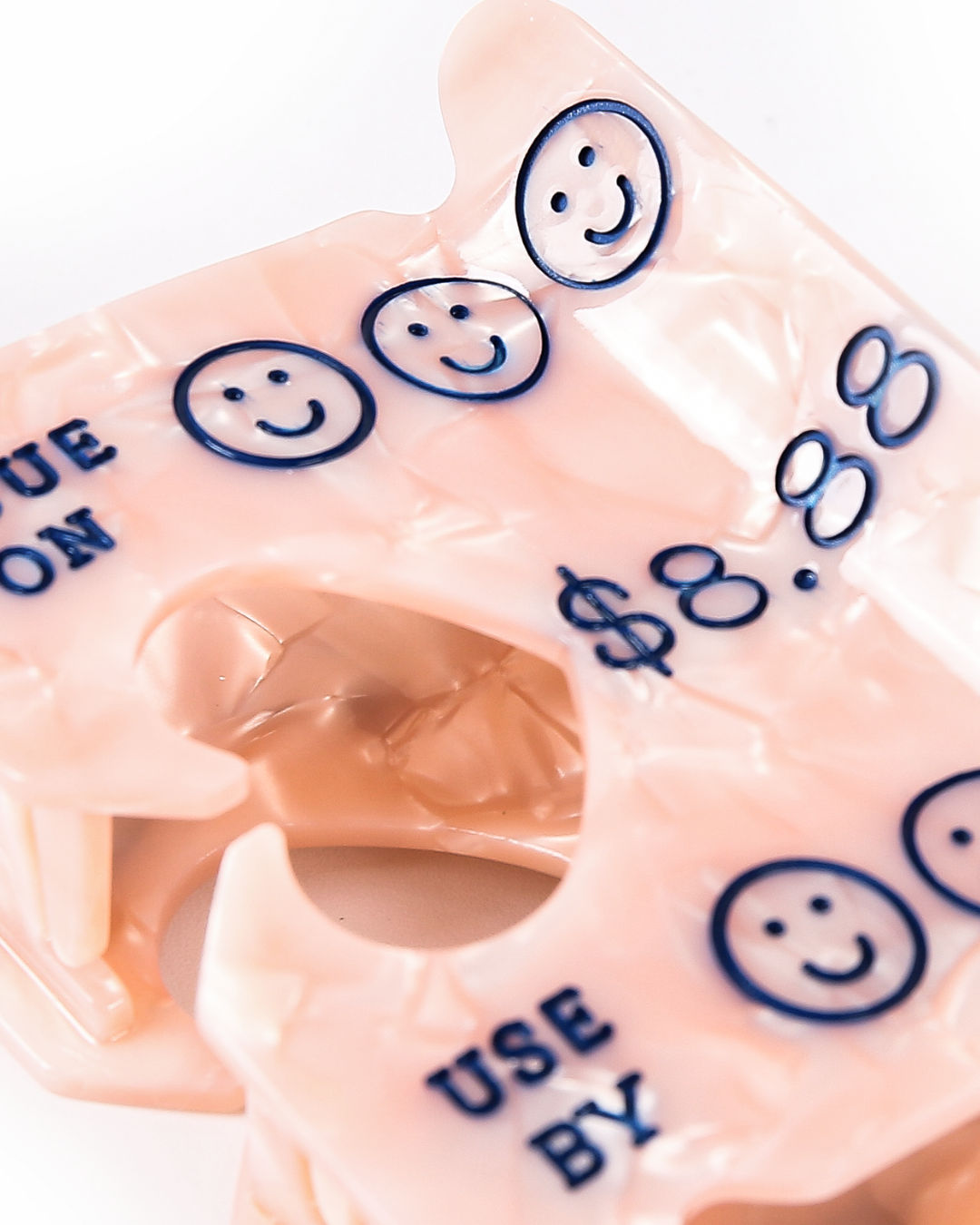 close up view on the details of the smiley faces on the bread tag hair claw