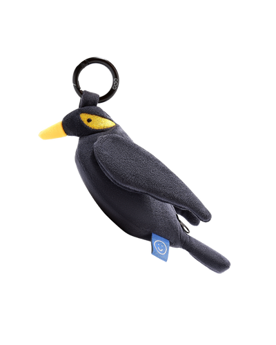 Black bird-shaped Mynah plushie reusable bag keychain with a yellow beak on a white background