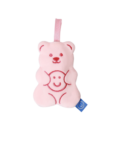 A small pink plushie bag in the shape of a gummy bear with red embroidery details.