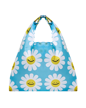 A reusable nylon shopping bag with a checkered blue and white pattern, featuring graphic designs of daisy flowers with smiling faces.