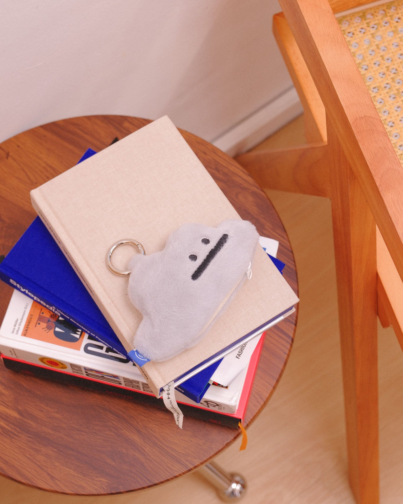 grey cloud plushie on a coffee table