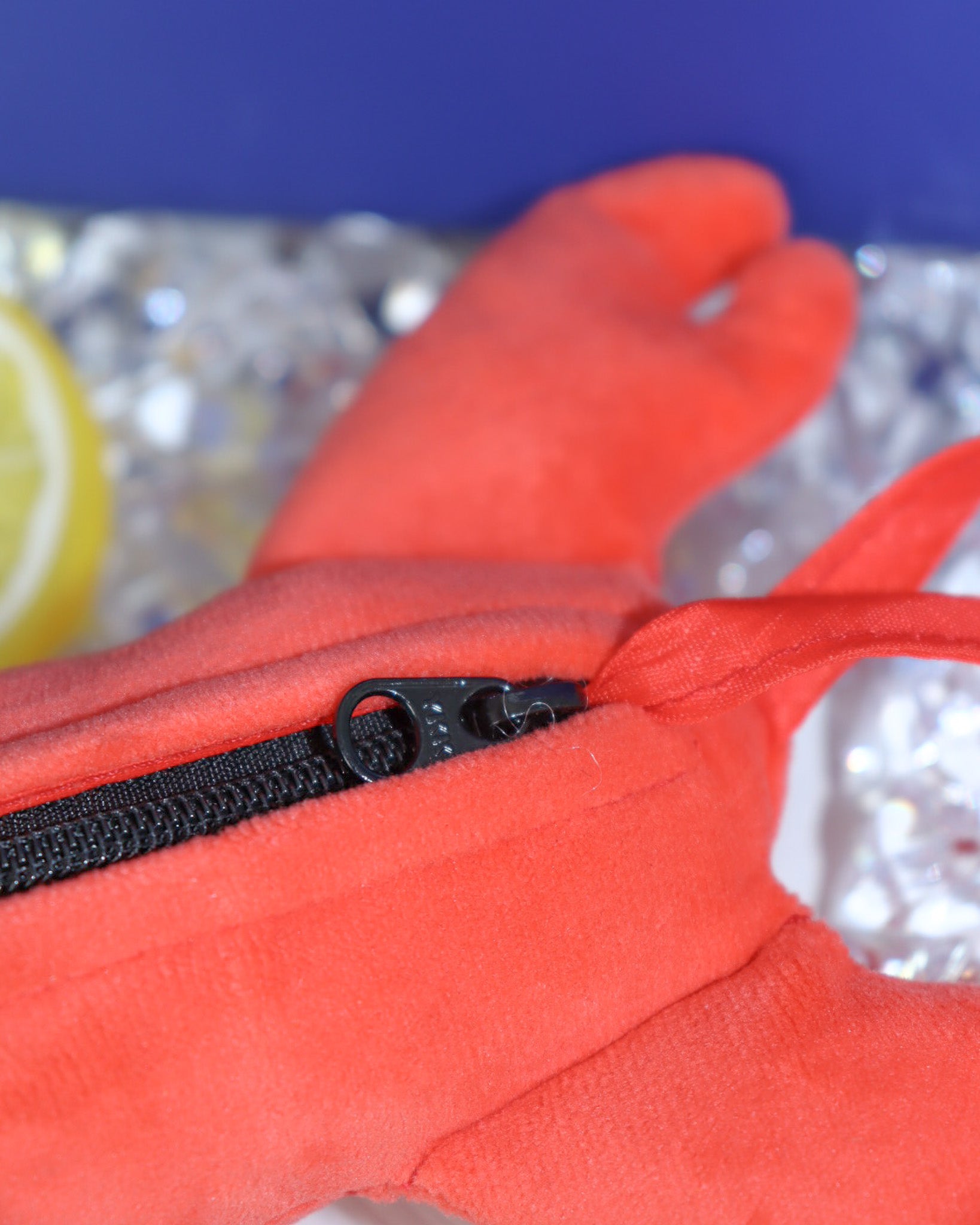 a close up look at the zip behind the lobster plushie