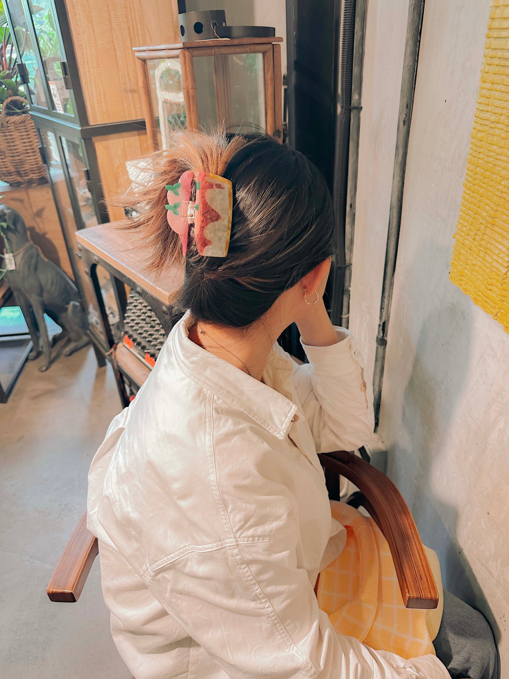 strawberry cheesecake claw clip used on a person's hair