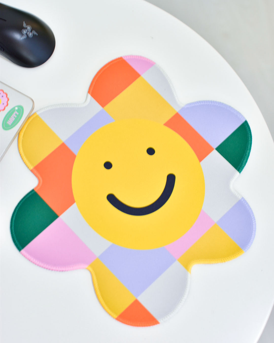 close up view of the front of the smiling checkered flower mousepad